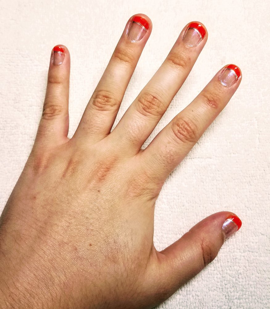 Clean red French tip manicure on a towel